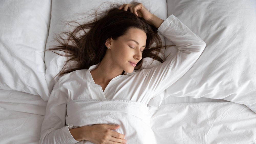 Woman peacefully sleeping on her back