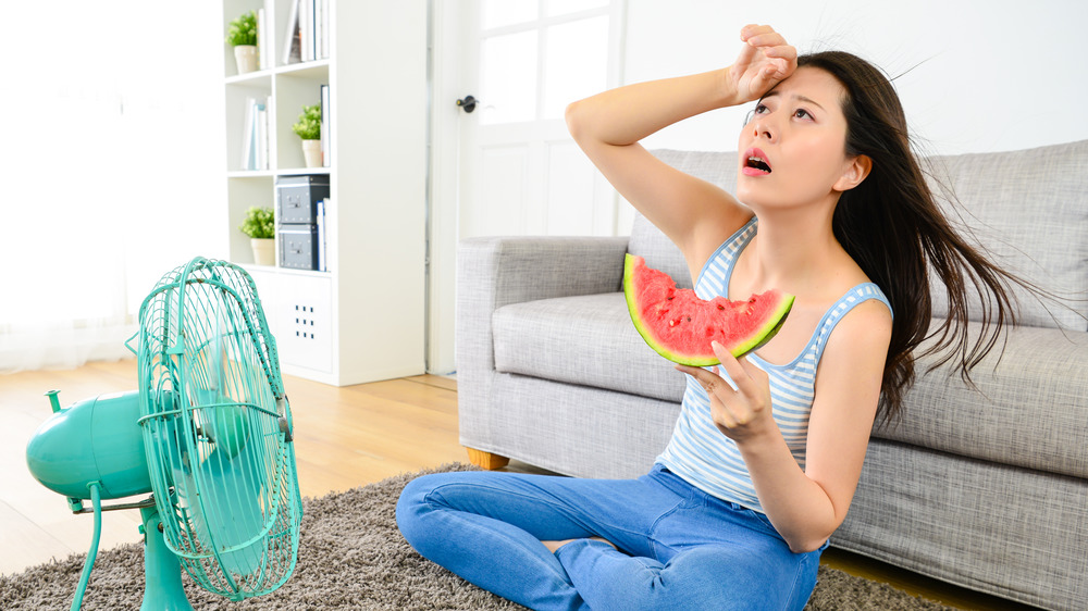 woman sweats while eating