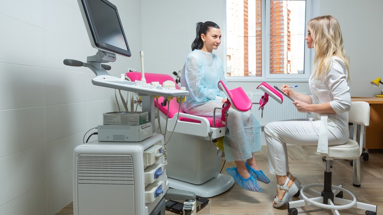 woman talking to gynecologist in office