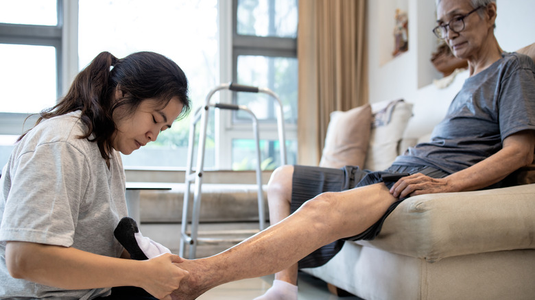 woman massaging man's feet
