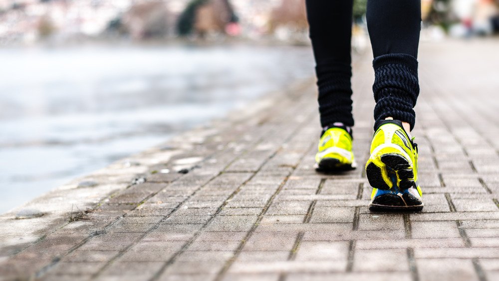 a man jogging outside with yellow training shoes 