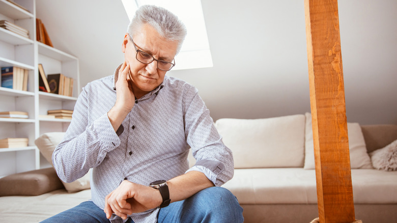 Man checking heart rate on smartwatch