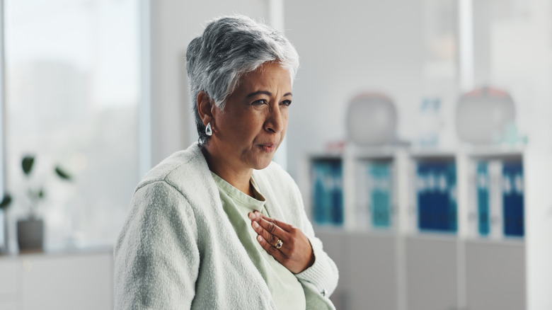 woman feeling heartburn pain
