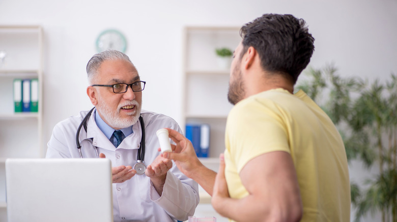 doctor explaining heartburn medication to patient