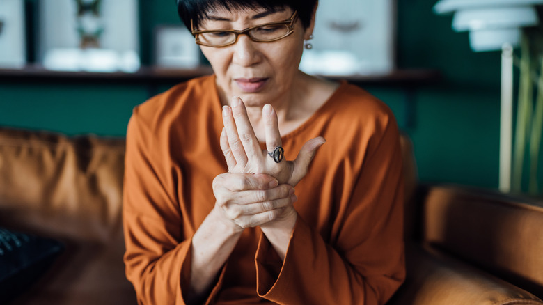 older woman looking at her hands