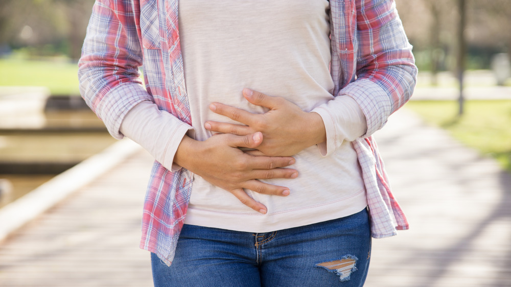 woman holding stomach