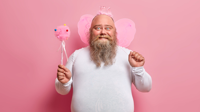 man in fairy suit with pink background
