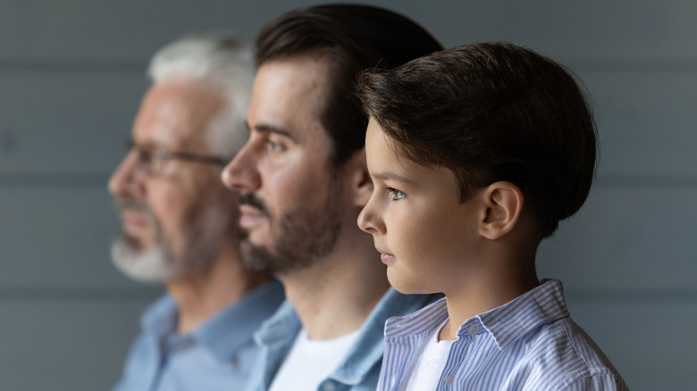 three males standing side by side