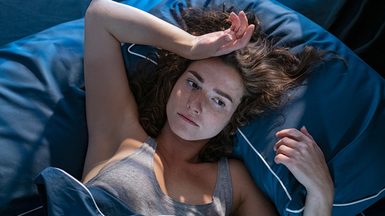 insomniac woman laying in bed