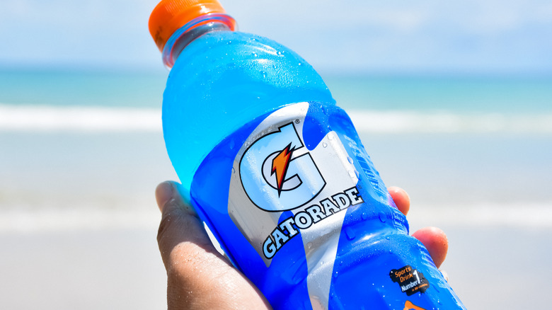 hand with gatorade on beach