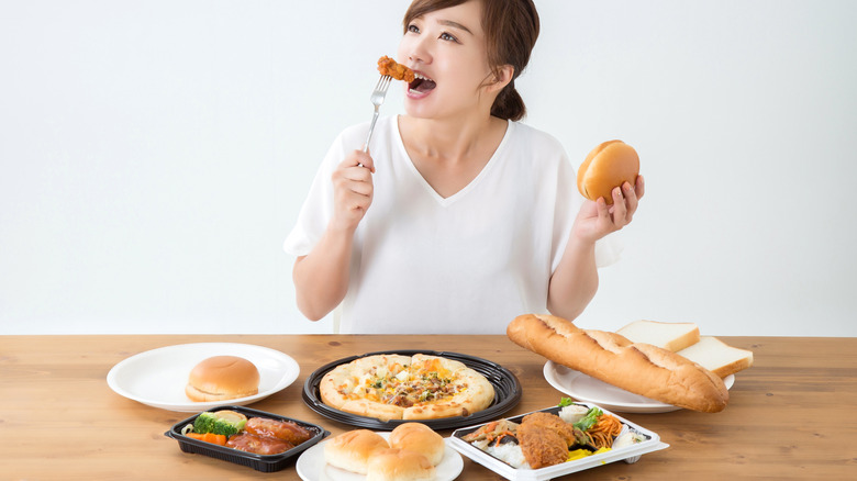 woman eating lots of fattening food