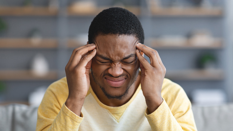 man suffering from migraine