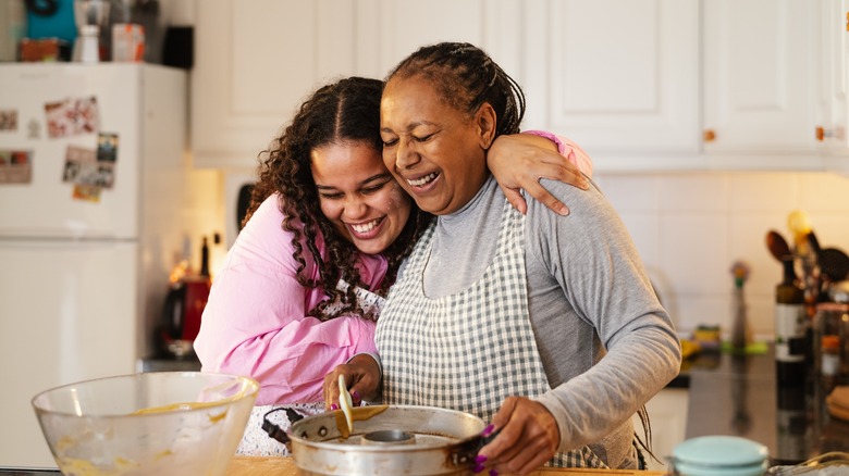 woman and granddaughter making homemade dessert