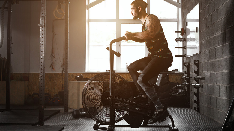 man riding stationary bike