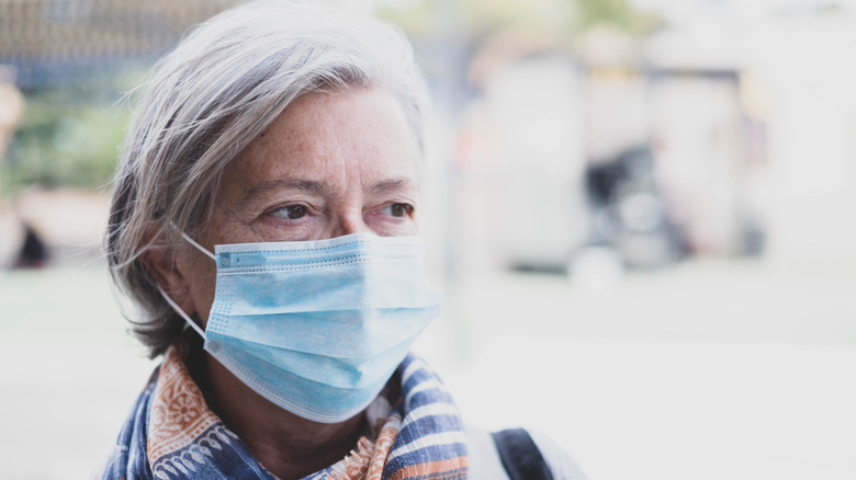 Older woman outside wearing mask