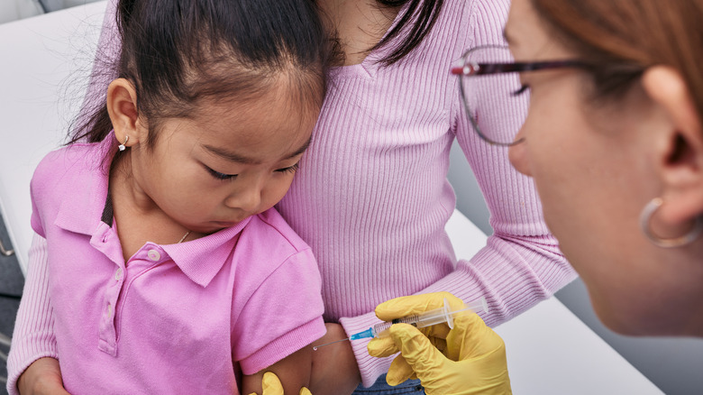 child receiving polio vaccine