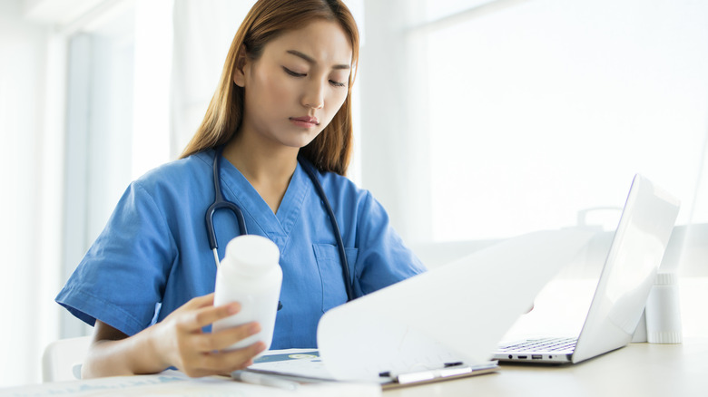 Doctor holding prescription pill bottle