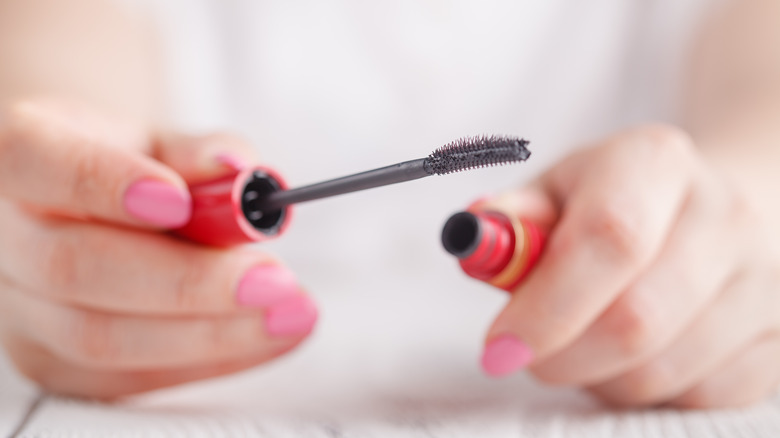 Hands holding mascara