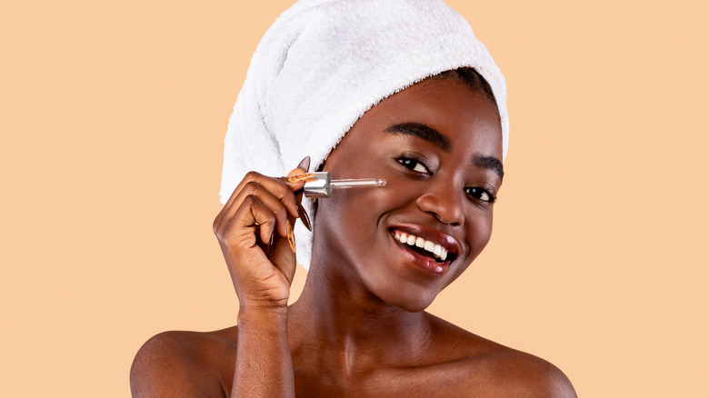 Woman applying retinol 