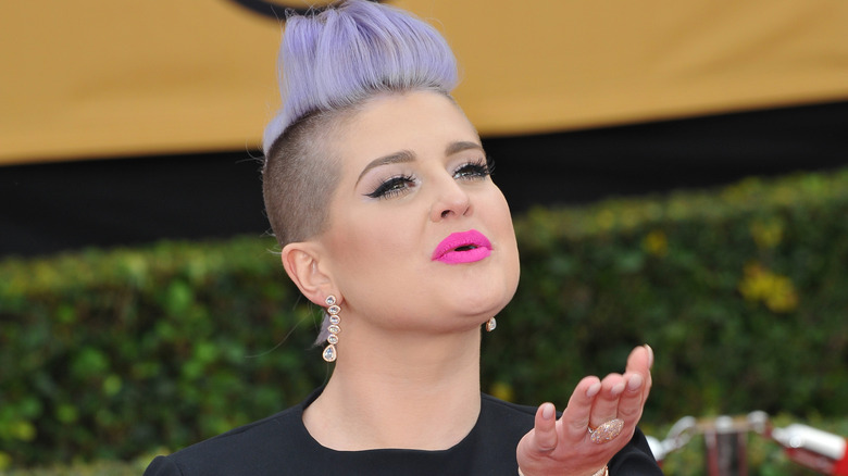 Kelly Osbourne blowing a kiss