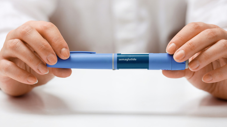 woman's hands holding a prescription of semaglutide