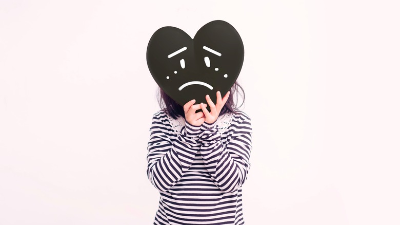 person in striped sweater with animated sad heart head