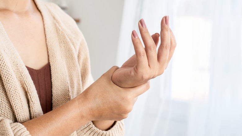 Woman massaging her painful wrist