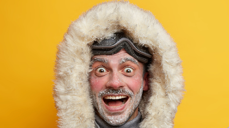Man in coat with frozen beard
