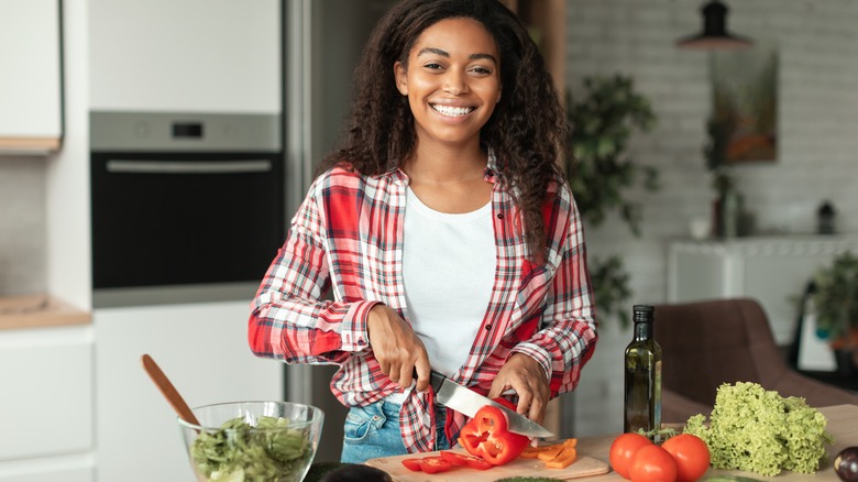 Young woman making a salad