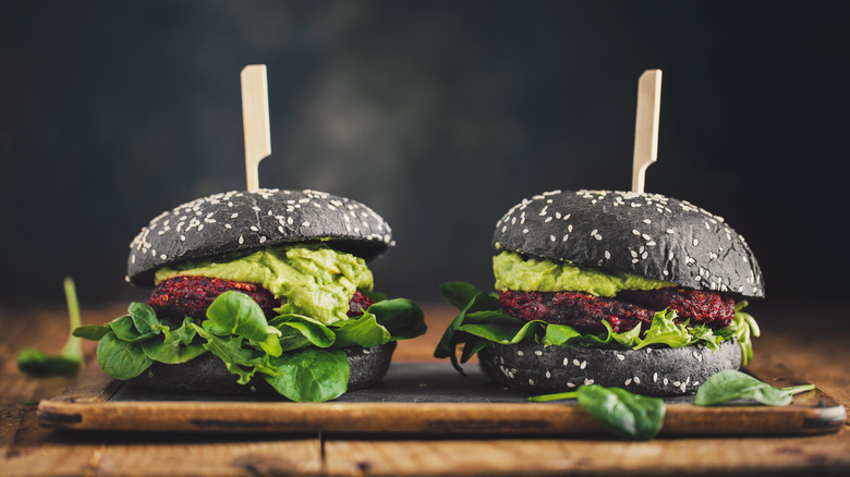 Black burgers with meat and avocado