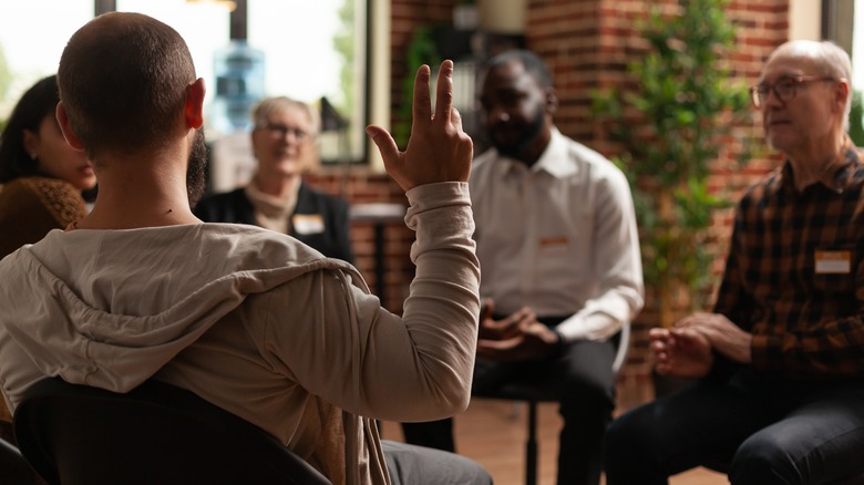 Man with addiction sharing health problems with group at AA meeting