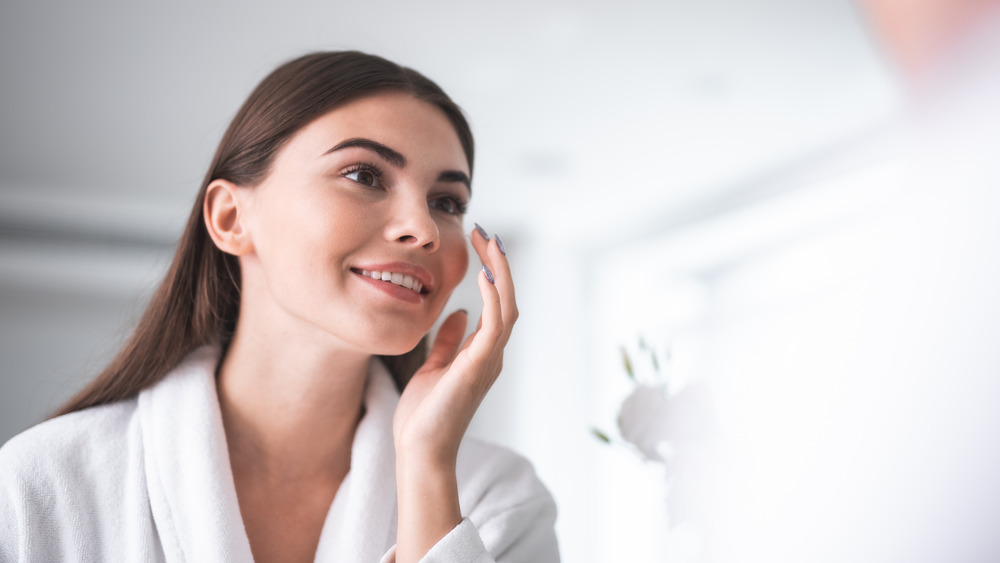 woman putting on face cream