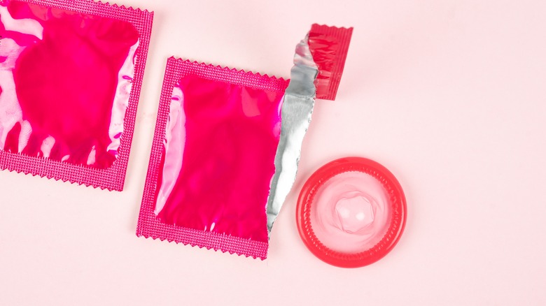 Open condom package with condom