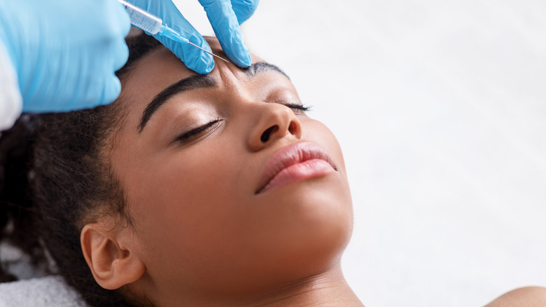 woman getting injection in forehead