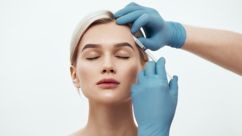 woman getting injection in forehead