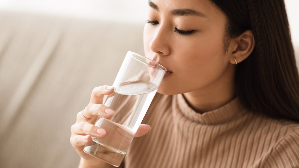 Woman drinking water from glass