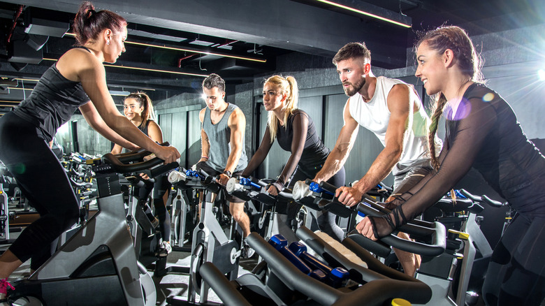 group of fit people taking a spin class