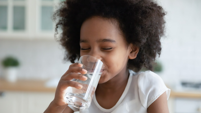 Girl drinking a glass of sparkling water