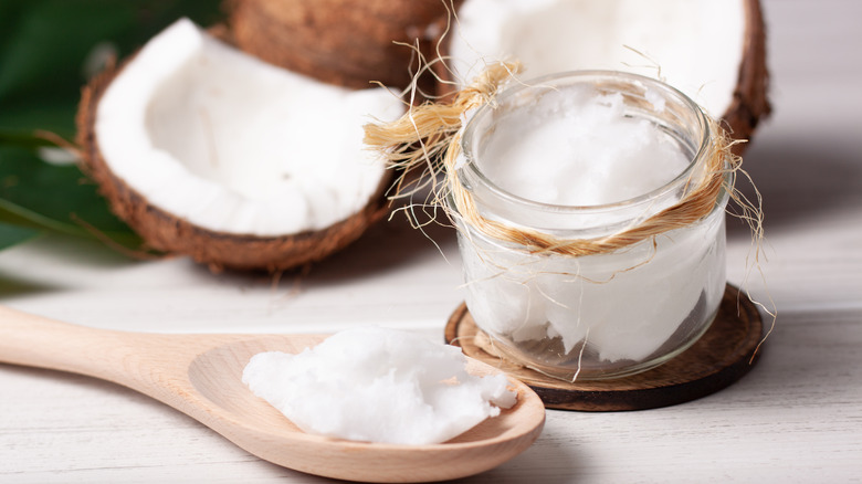 a jar and spoon filled with coconut oil 