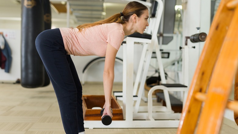 woman deadlifting in gym