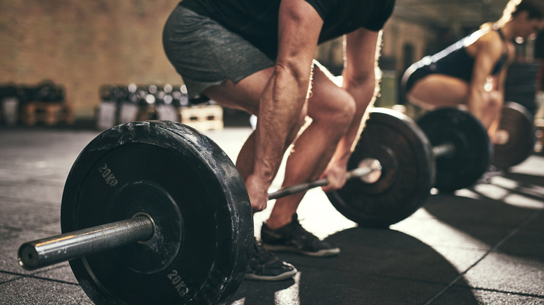 man deadlifting heavy weight