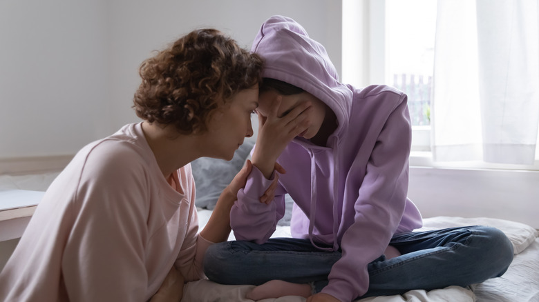 Mother and daughter sharing an intense emotional moment \