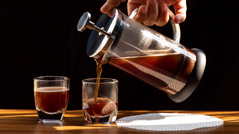 Hand pouring French press coffee