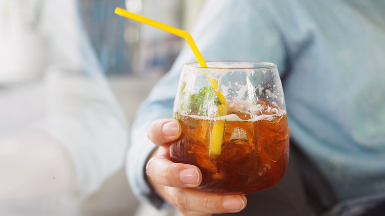 Man holding a glass of ginger ale