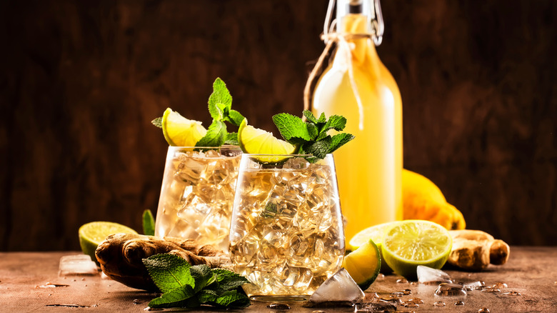 Two glasses of ginger ale on a wooden table