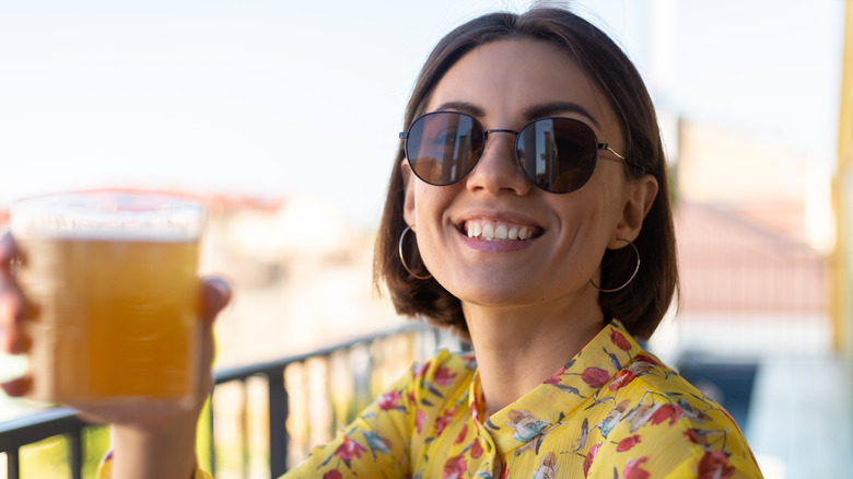 a woman drinking kombucha 