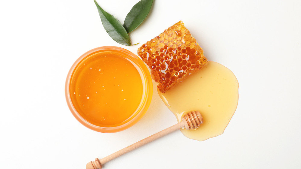 Honey and a honeycomb on a white background