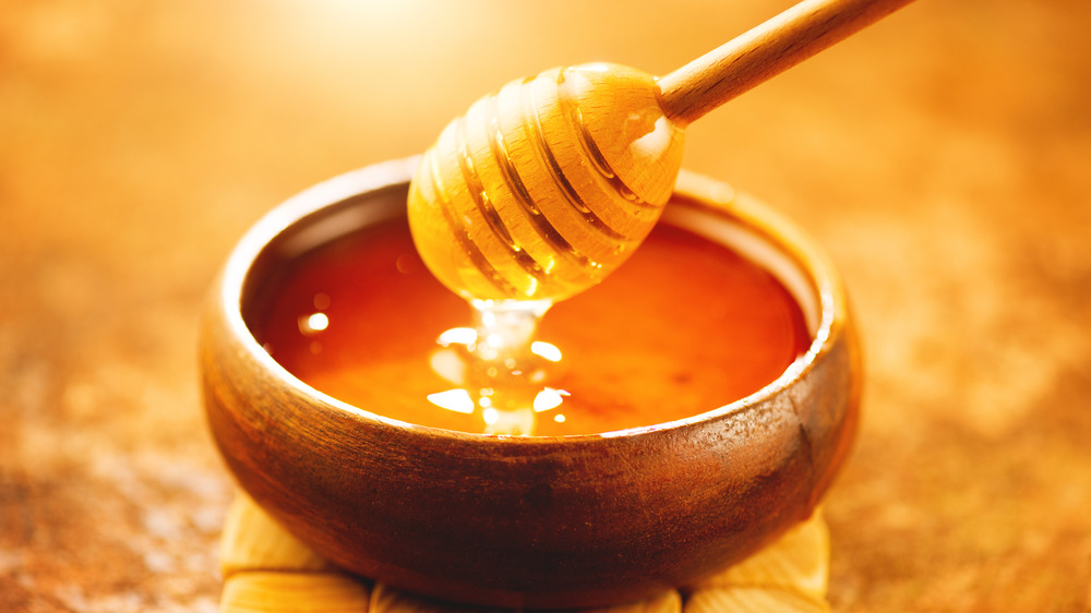 Honey dripping from honey dipper