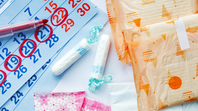 Menstruation products and calendar with red marked dates