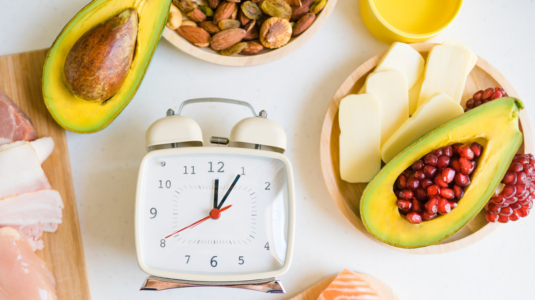 clock surrounded by avocados and foods
